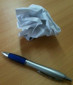 pen and scrunched up paper
